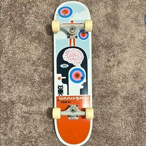 Vibrant Orange and White Toy Skateboard with Abstract Design
